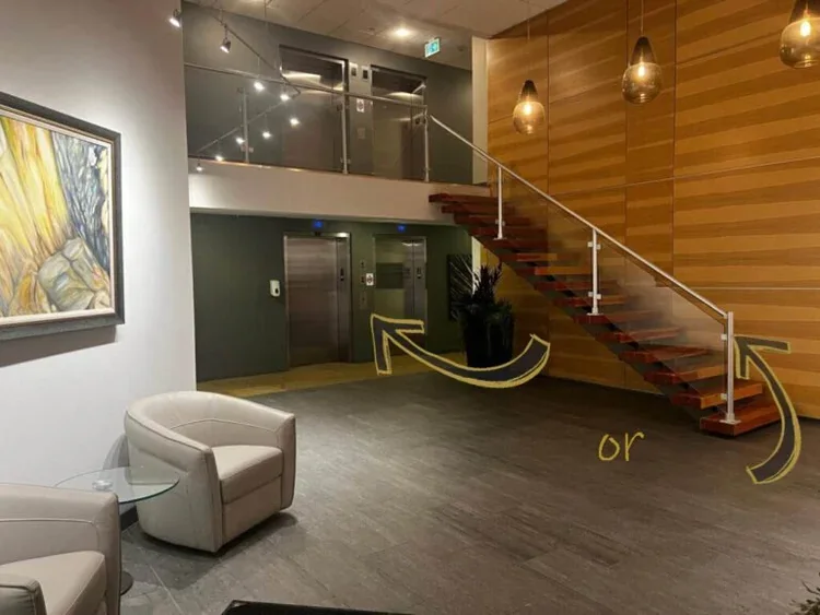 Building lobby showing the elevator and staircase to the first floor